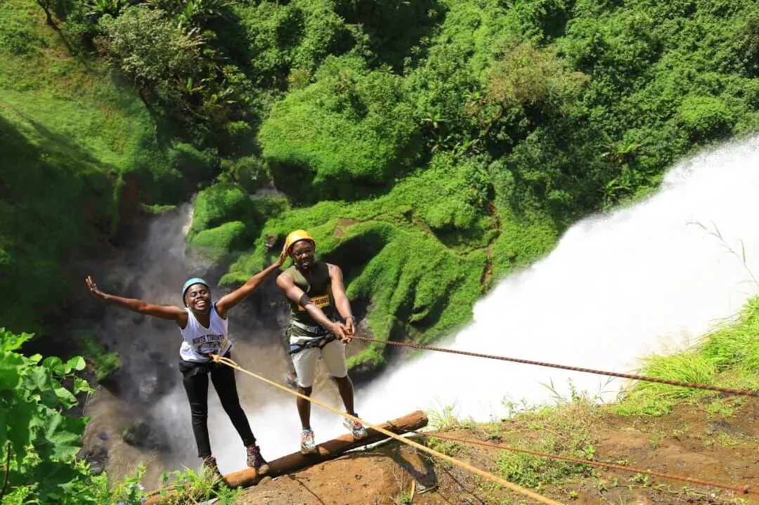 Tourists abseiling down Sipi Falls